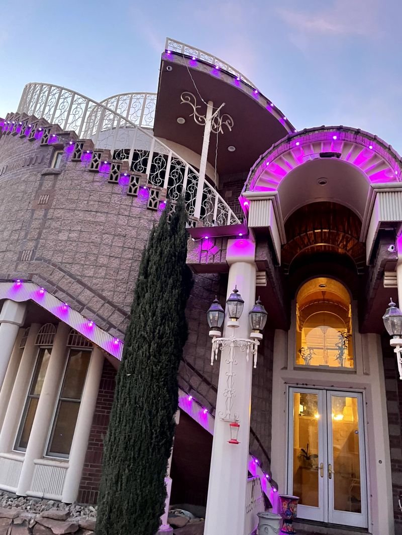 Architectural permanent lighting picking out arches, columns and rooflines at dusk