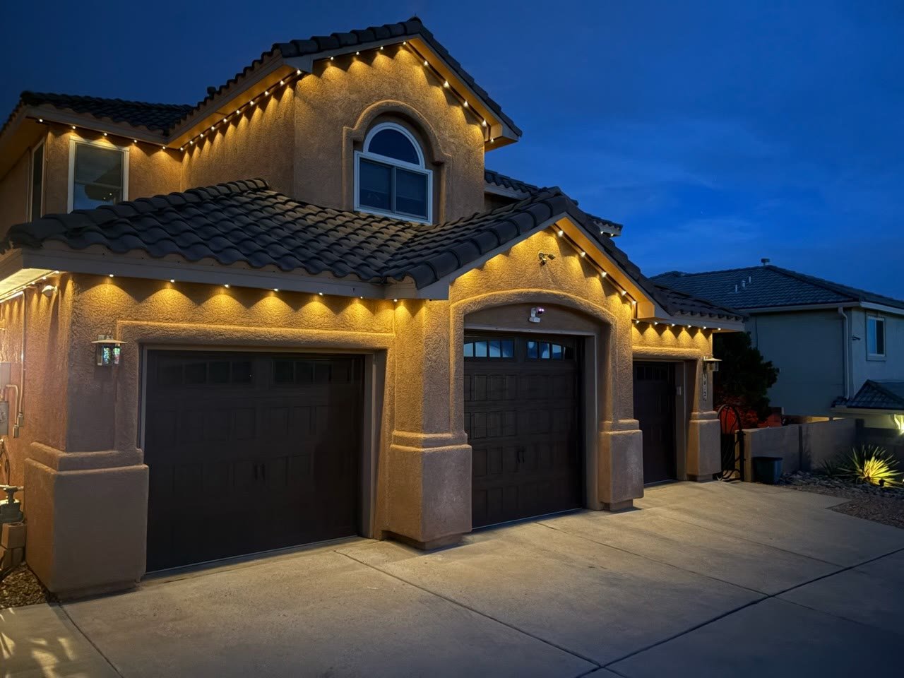 Albuquerque home with permanent lighting running the roofline, gables and eaves in everyday warm white